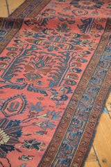 Persian Lilihan runner's madder red field, sprawling indigo floral motifs, and intricate border.