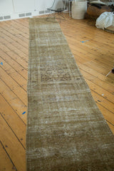 Distressed vintage Malayer runner with faded bronze, moss Herati pattern and secured edge.