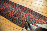 Splayed floral cross sections and medallions in madder red, sky blue, and mallard green.