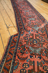 Vintage Lilihan rug, hand-knotted madder red field with splayed floral motifs and dark blue border.
