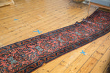 Vintage Lilihan runner showcasing allover madder root red field with splayed floral, pinwheel motifs.