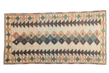 Vintage distressed Turkish Dosmealti rug, geometric diamonds and navy zigzags on an ivory field.