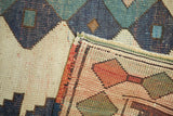 Textural detail of the distressed Dosmealti rug showing geometric patterns and original side cord.