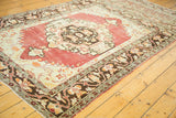Distressed Oushak rug with triclinium top niche in faded cherry, antique ivory, and brown.