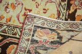 Secured red selvage, hand-knotted foundation, and distressed pile in faded red and orange tones.