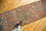 Distressed vintage Hamadan runner with a faded blush field, blue floral medallions and vinery.