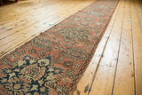 Distressed vintage Hamadan runner displaying blush and charcoal floral medallions, vinery.