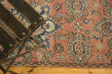 Blush field of a distressed Hamadan runner showing floral vinery and meandering border.