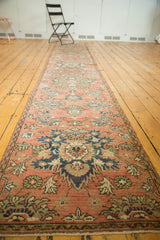 Distressed Hamadan runner border with meandering vine motif and muted blush floral field.