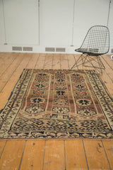 Vintage Oushak rug's secured end with short fringe and geometric border.