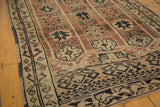 Detailed view of vintage Oushak rug's geometric border and roundel motifs in copper, bronze, beige.