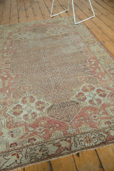 Distressed Oushak rug with muted blush, ivory field, and visible foundation wear.