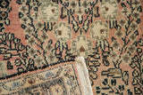 Dusty rose, blush floral spray motifs and intact plain weave on a vintage Lilihan rug corner.