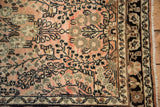 Vintage Persian Lilihan rug close-up: dusty rose floral field, ornate multi-banded border.