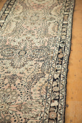 Intricate dusty rose floral spray bouquets on a vintage Lilihan rug runner.
