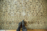 Distressed vintage Sivas carpet detail with time-softened hues, Herati pattern, and lotus palmette border.