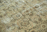 Textured Herati motif on a distressed Sivas rug, revealing pale peach and chocolate brown tones.