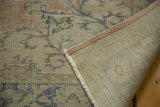 Vintage distressed Oushak rug: reverse, dusty rose side, and muted floral pattern detail.