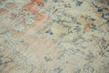 Hard distressed texture and exposed foundation of a Vintage Oushak rug with blush, ivory, blue.