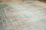 Distressed texture of vintage Oushak rug with blush, antique ivory, and navy hues.