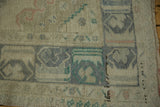 Distressed Oushak runner detail: abrash texture, muted blues, beige, and soft pink geometric forms.