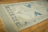Pale blue geometric border with distressed ivory pile on vintage Oushak rug.