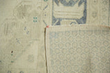Distressed ivory Oushak rug pile texture with its woven pale blue foundation.