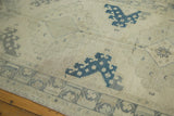 Abrasions and subtle stain on the distressed ivory Oushak runner with dark denim blue motif.