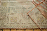 Distressed texture, stepped geometric border, and fringe of a vintage Oushak rug.