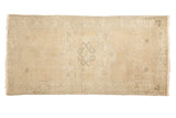 Distressed Oushak runner with faded medallion, cloud band details, beige, ivory, saffron.