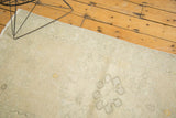 Soft distressed texture of vintage Oushak rug in muted beige with saffron highlights.