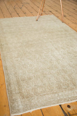 Decorative distressed texture and subtle Mir Boteh pattern of the vintage Oushak rug.