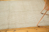Distressed vintage Oushak rug showing subtle Mir Boteh pattern and soft neutral hues.