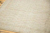 Distressed vintage Oushak rug pile with even wear, showing subtle ivory and beige tones.