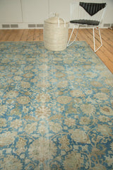 Distressed vintage Tabriz carpet with faded sky blue and dusty gold floral patterns.