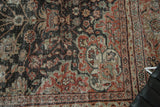 Textured distressed Mahal rug showing worn pile, scrolling vinery in charcoal, red, and sea foam.