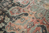 Textured distressed Mahal carpet with scrolling vinery in charcoal, madder red, and sea foam.