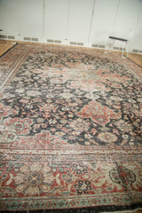 Distressed vintage Mahal carpet detail: worn charcoal, madder red, and ivory scrolling floral vinery.