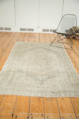 Distressed Oushak runner end, muted ivory and sand tones with subtle pattern and secured fringe.