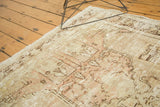 Worn pile texture of a distressed vintage Oushak rug, revealing ivory, blush, and brown.