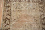 Distressed Oushak runner showing worn pile texture, visible foundation, and light brown motifs.