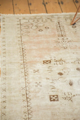 Distressed Oushak runner, worn beige, blush pile and foundation, with brown geometric motifs.