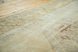 Oushak runner close-up showing distressed pile with beige tones and shadow quatrefoil design.