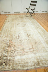 Vintage Distressed Oushak runner's faded beige, mauve corner spandrel and worn texture.