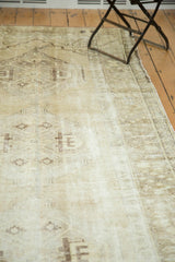 Distressed vintage Oushak runner with worn beige patterns and visible low pile areas.