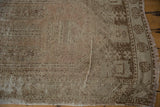 Distressed pile and muted geometric border details on a hand-knotted vintage Oushak runner.