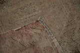 Distressed Oushak runner corner highlighting textured wear, visible foundation, and soft colors.