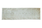Hand-knotted distressed vintage Oushak runner, faded ivory and pale brown quadruple medallions.