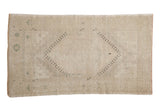 Hand-knotted distressed Oushak rug, octagonal medallion, geometric patterns, muted beige and pale green.