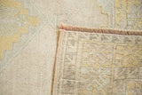 Hand-knotted foundation, secured end, and soft pile of vintage Oushak rug.
